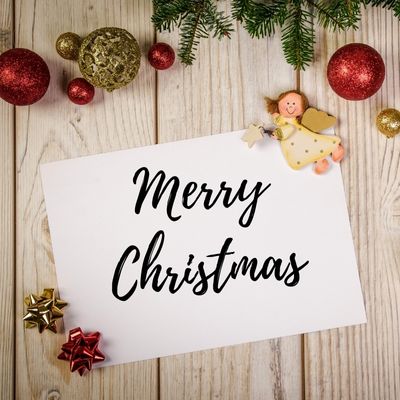 wishing a merry Christmas with white background text and green and red Christmas decoration