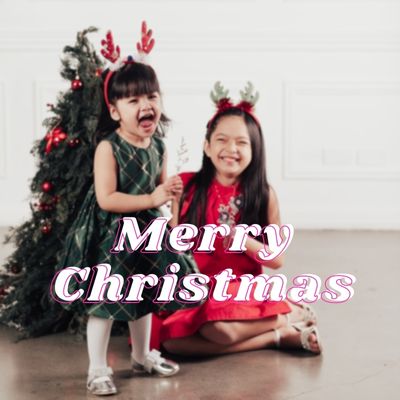 two girls with wish a merry Christmas